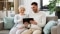 family, technology and people concept - happy adult son teaching his senior mother how to use tablet computer at home; Shutterstock ID 1428376514; Purchase Order: 061
