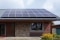 The image shows solar panels on the roof of a house